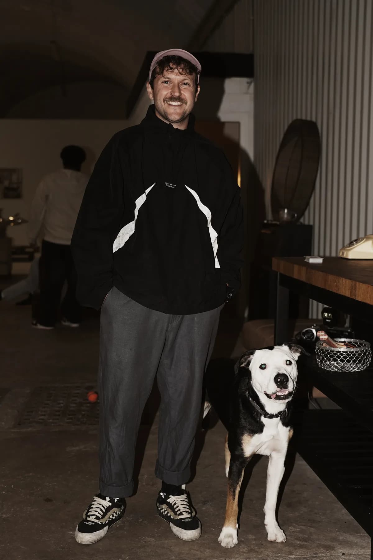 James, founder of OmniOps, standing with his dog